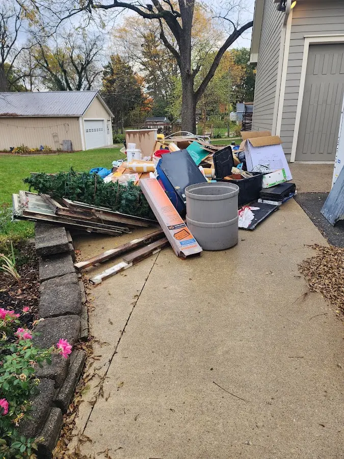 Dumpster being loaded with debris for Residential Dumpster Rental in Woods Creek